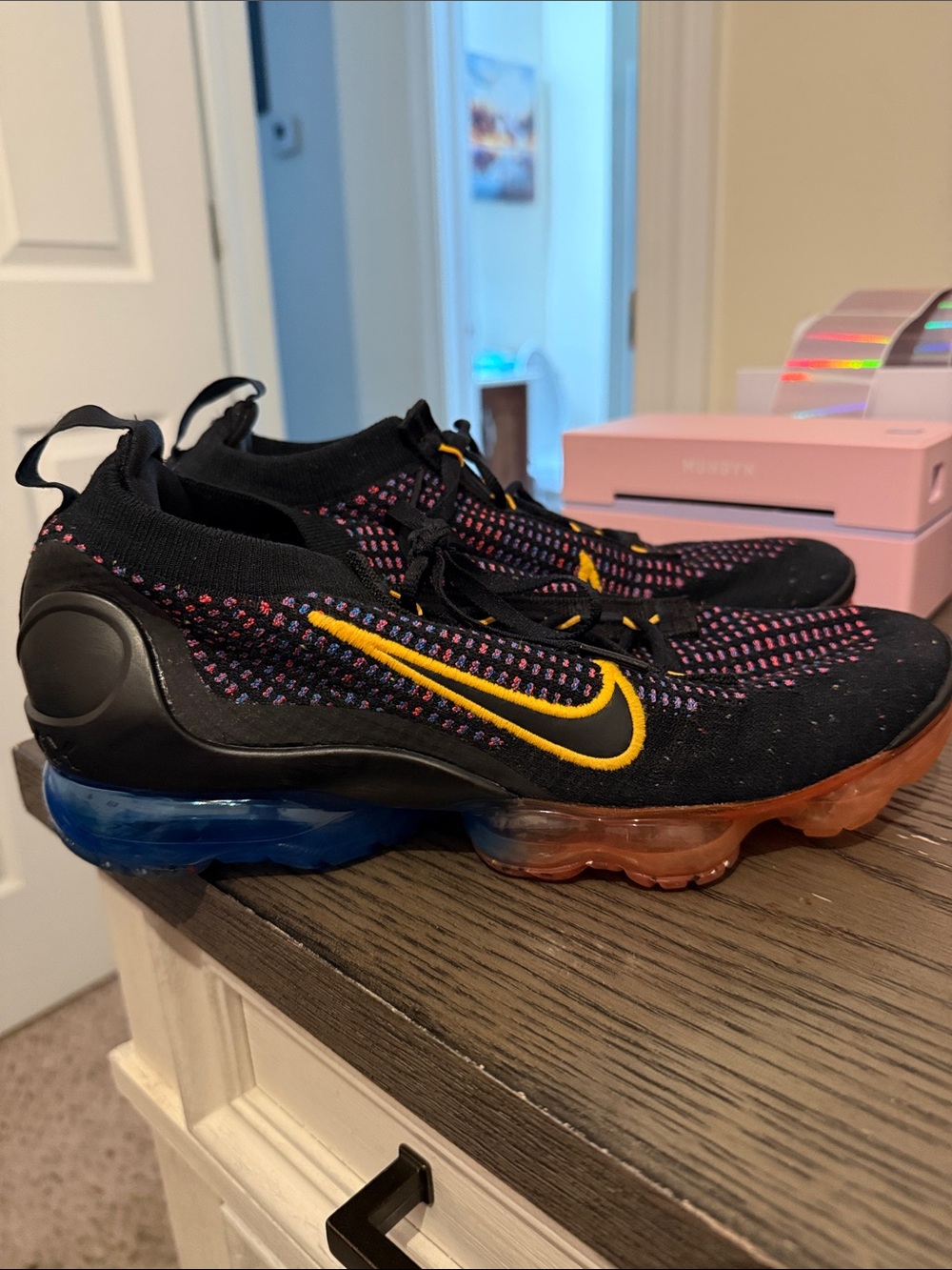 Nike Black Flyknit Athletic Shoes with Yellow Swoosh and Blue-Orange Air Sole